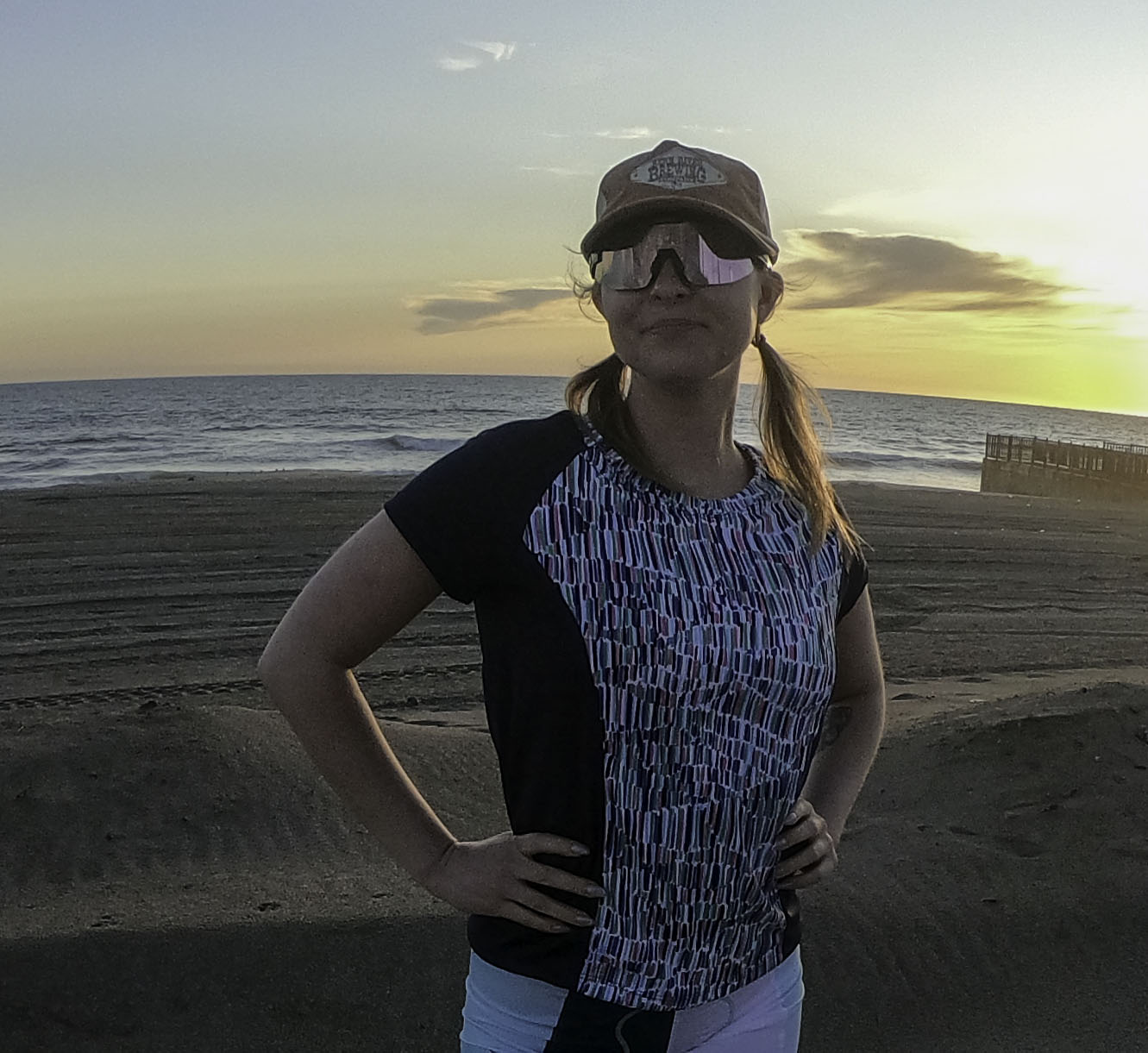 Moxie Tee Jersey Blues Long Sleeve in Purple Paisley design, worn by the beach at sunset.
